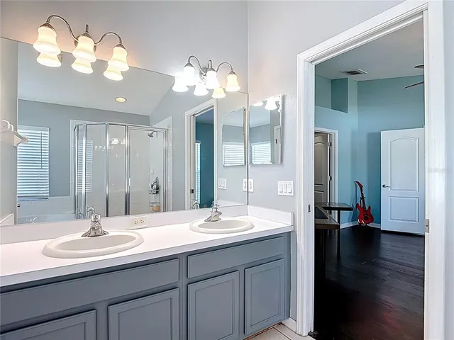 a kitchen with stainless steel appliances granite countertop a sink and a white cabinets