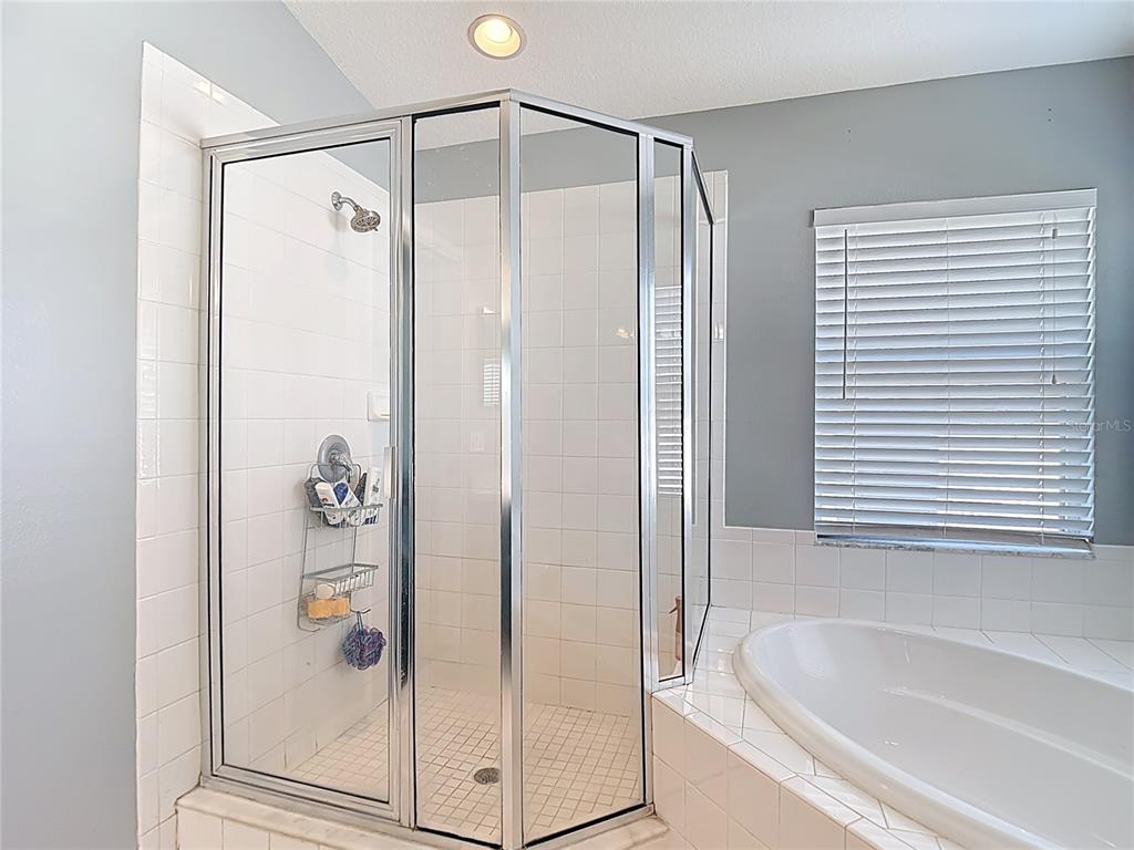 12153 South Bridge Terrace Hudson, FL 34669 - Photo 46 of 60 a bathroom with a glass shower door and a shower