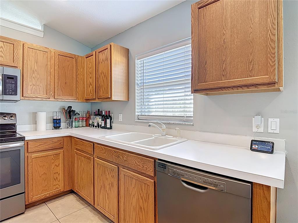 12153 South Bridge Terrace Hudson, FL 34669 - Photo 53 of 60 a kitchen with stainless steel appliances granite countertop a sink and a white cabinets