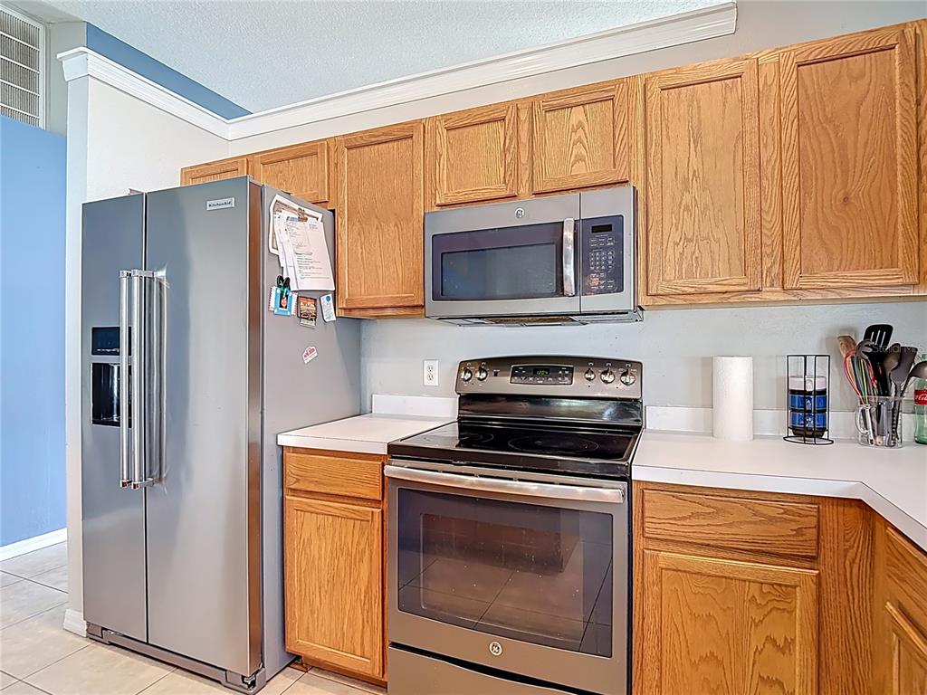 12153 South Bridge Terrace Hudson, FL 34669 - Photo 54 of 60 a kitchen with a stove microwave and refrigerator
