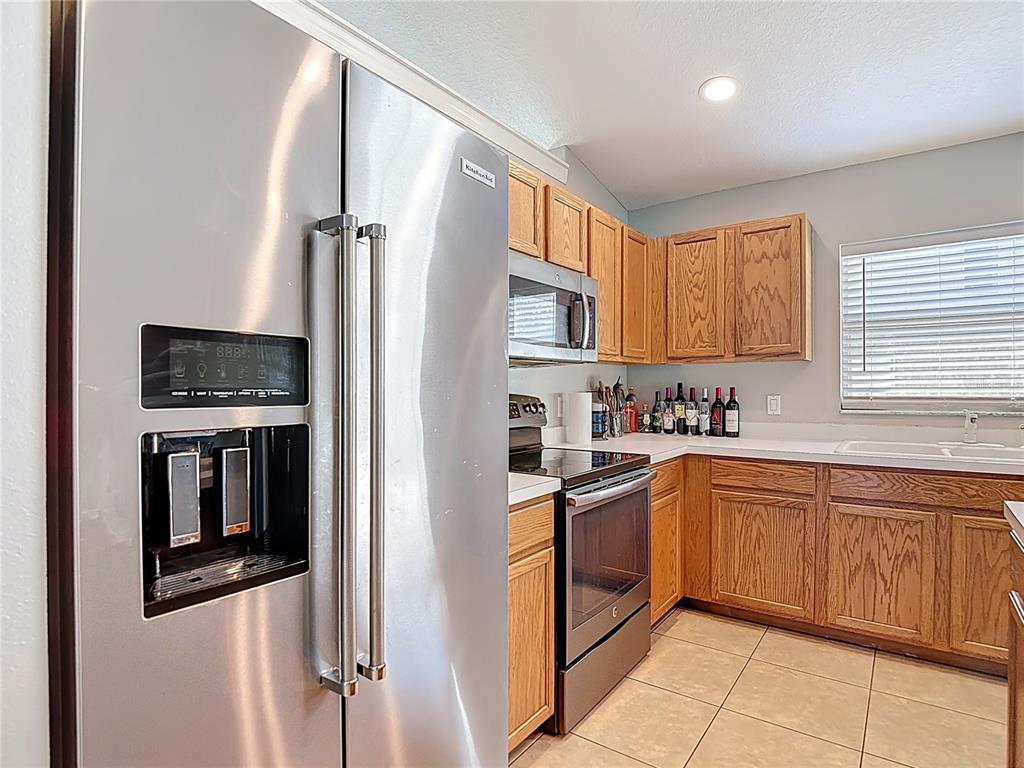 12153 South Bridge Terrace Hudson, FL 34669 - Photo 56 of 60 a kitchen with stainless steel appliances granite countertop a refrigerator and a sink