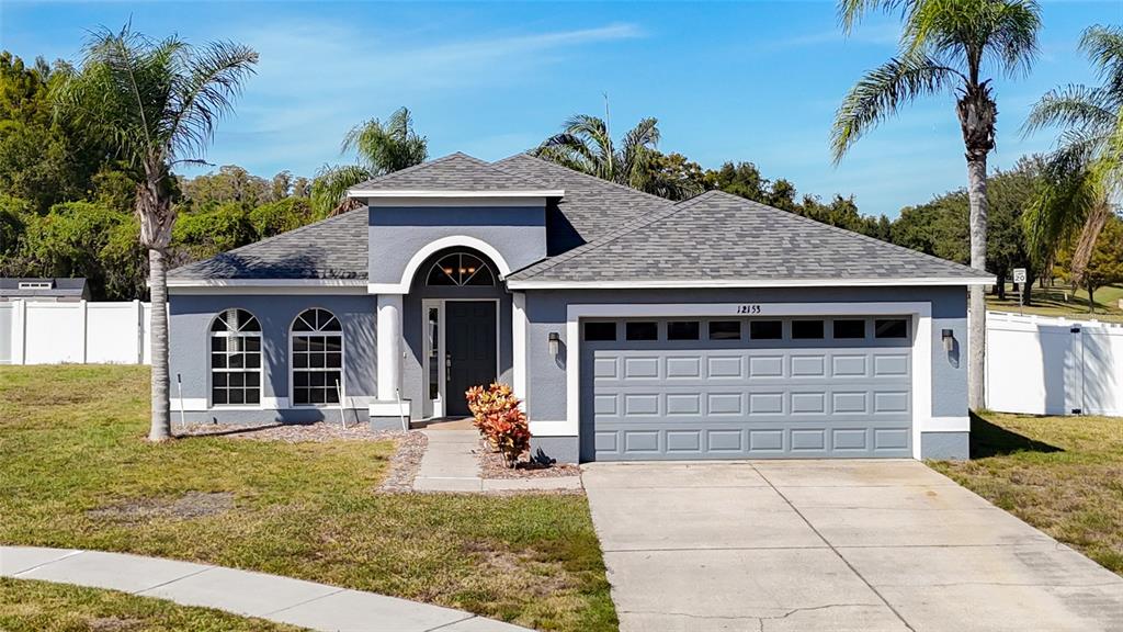 12153 South Bridge Terrace Hudson, FL 34669 - Photo 58 of 60 a front view of a house with garden