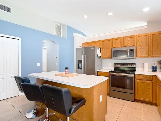 a kitchen with stainless steel appliances granite countertop a sink and a window