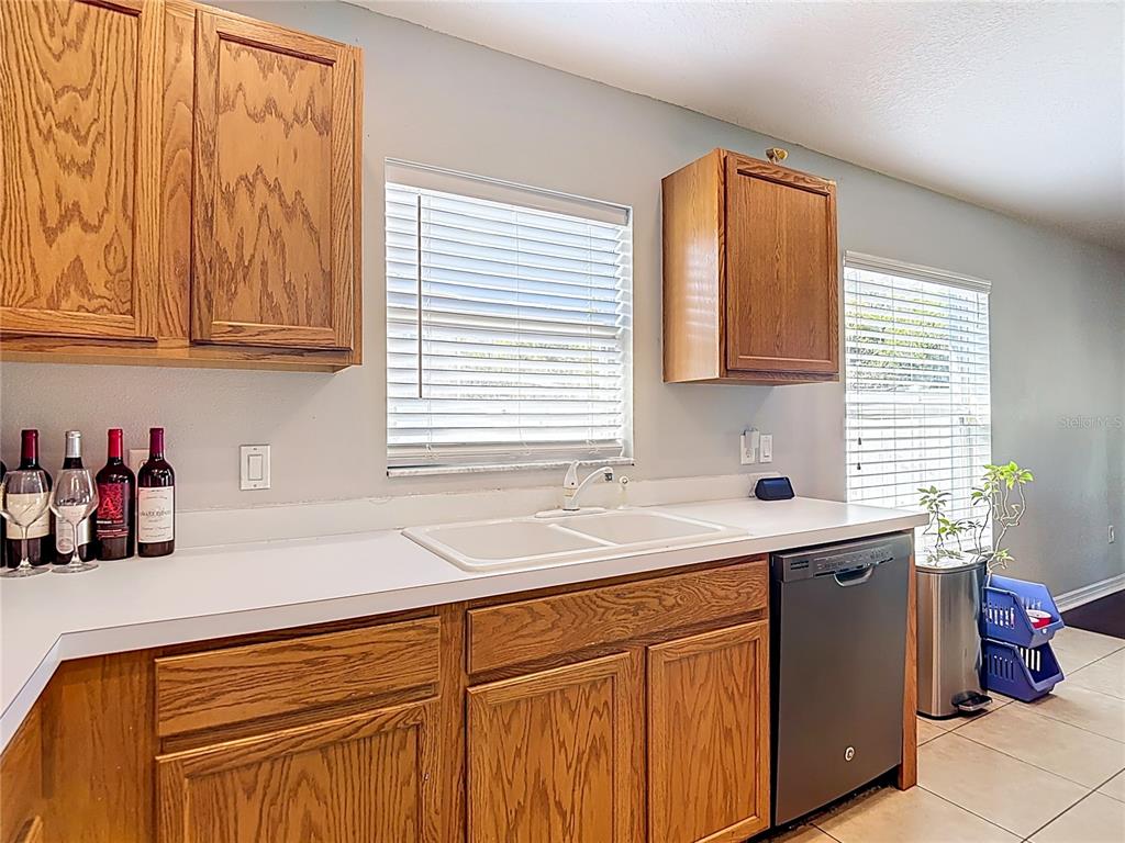 12153 South Bridge Terrace Hudson, FL 34669 - Photo 10 of 60 a kitchen with stainless steel appliances granite countertop a sink and a window
