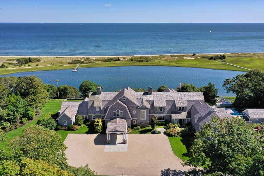 an aerial view of a house with a swimming pool yard and outdoor seating