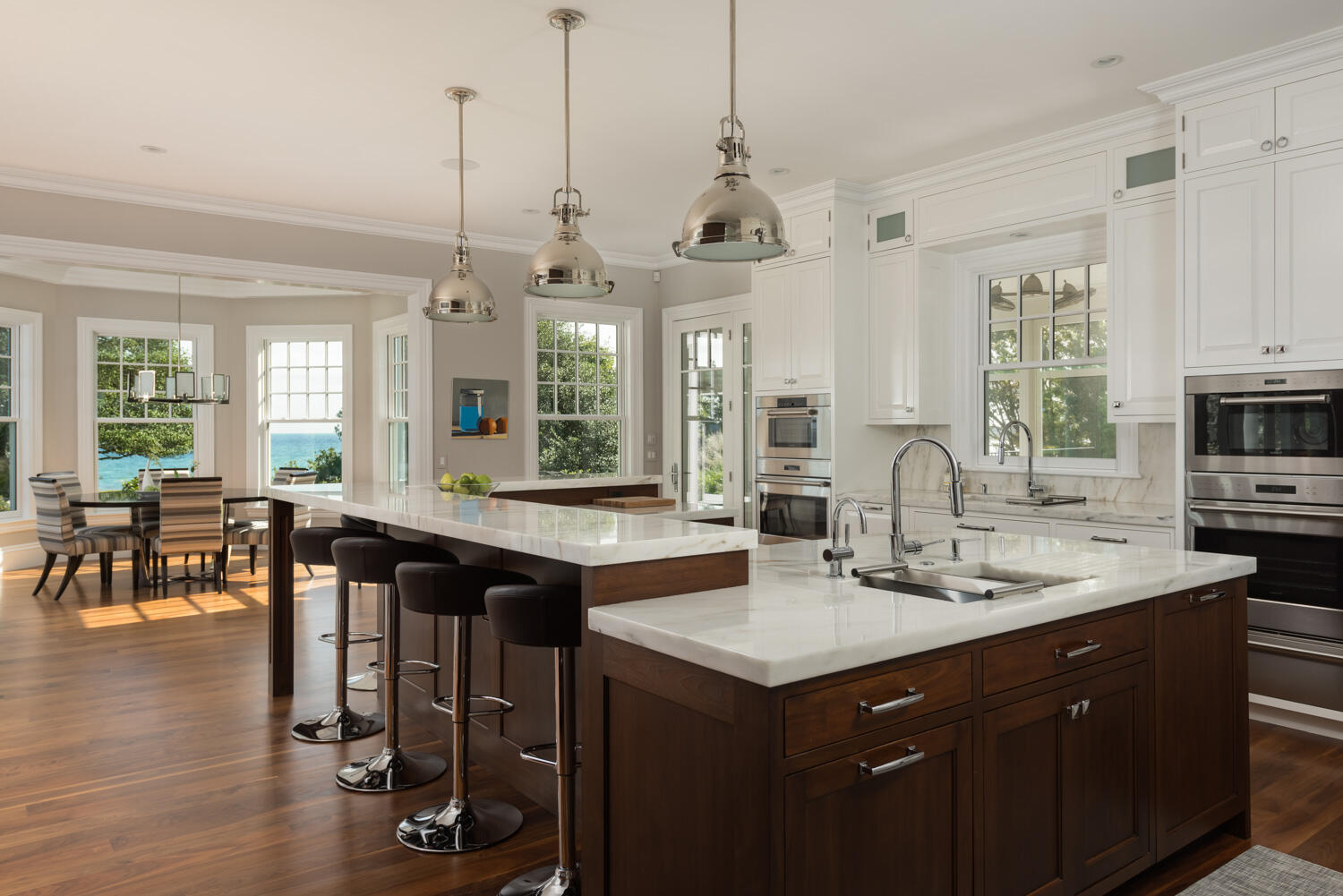 159 Main Street Osterville, MA 02655 - Photo 26 of 56 a kitchen with stainless steel appliances granite countertop a sink a stove a dining table and chairs