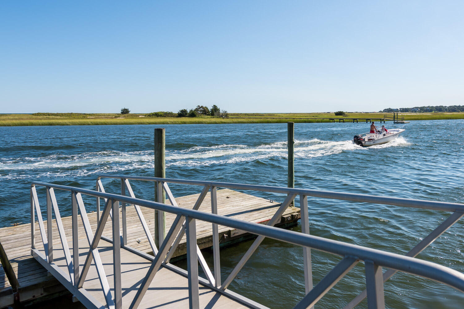 159 Main Street Osterville, MA 02655 - Photo 52 of 56 a terrace with a table and chairs a barbeque with wooden floor
