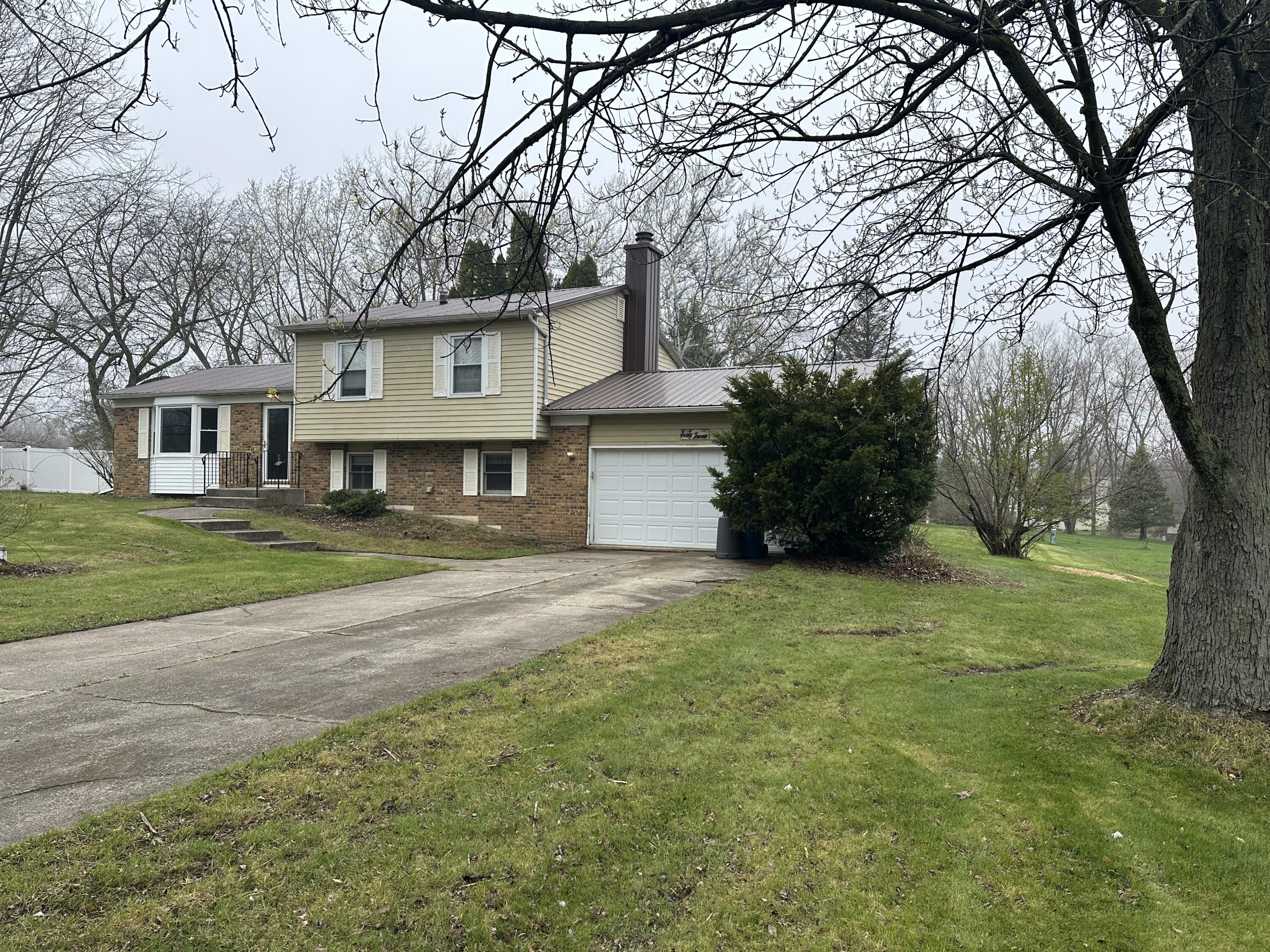 67 Brookview Lane Valparaiso, IN 46385 - Photo 1 of 16 a front view of a house with a garden