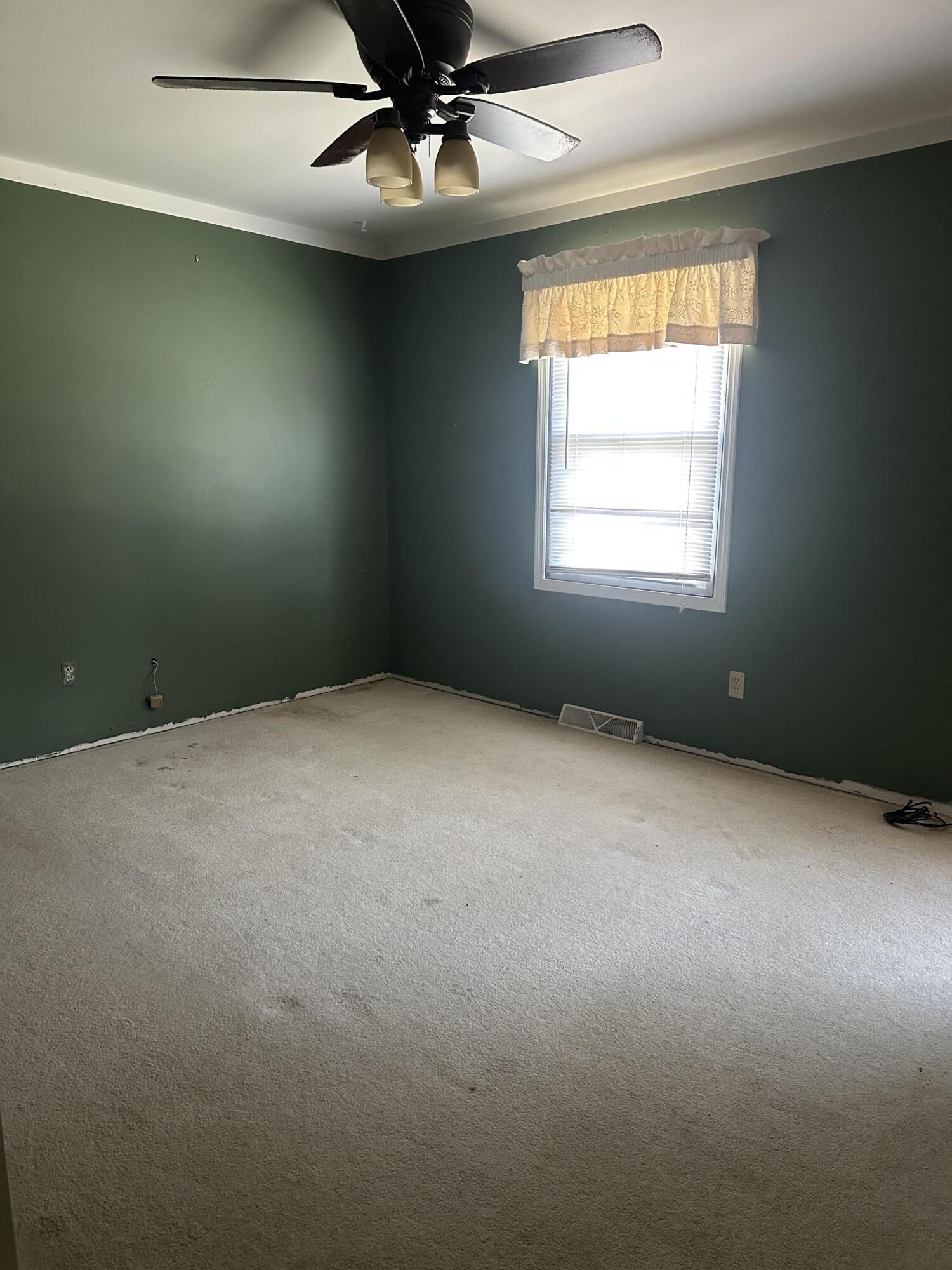 67 Brookview Lane Valparaiso, IN 46385 - Photo 3 of 16 an empty room with a window and a fan