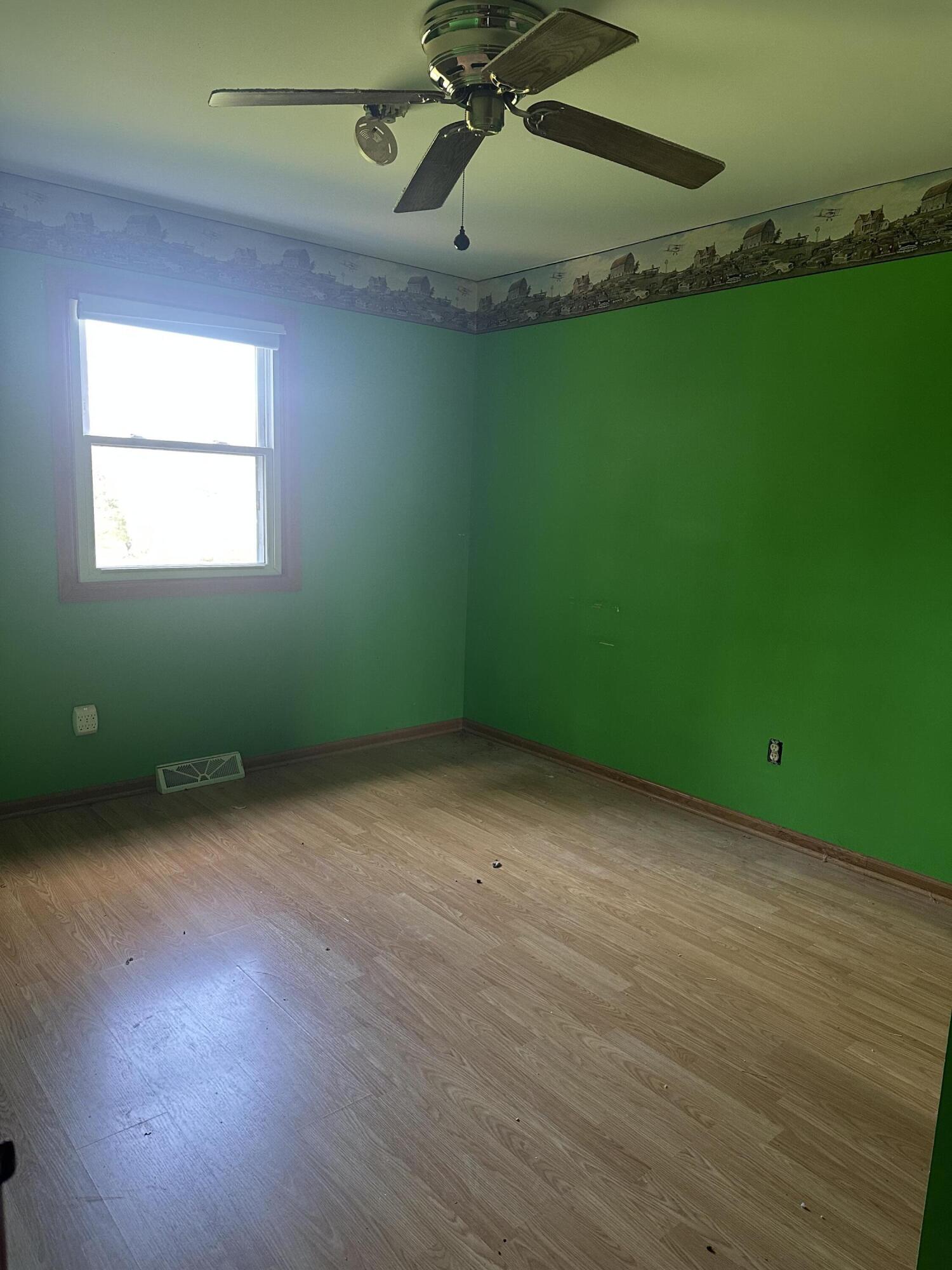 67 Brookview Lane Valparaiso, IN 46385 - Photo 4 of 16 an empty room with wooden floor and windows