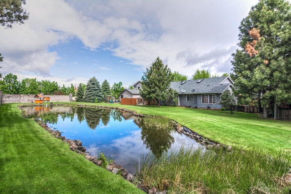 3393 Northeast Stonebrook Loop Bend, OR 97701 - Photo 5 of 23 Backyard pond and lawn off the patio and views from the primary bathroom and Flex room