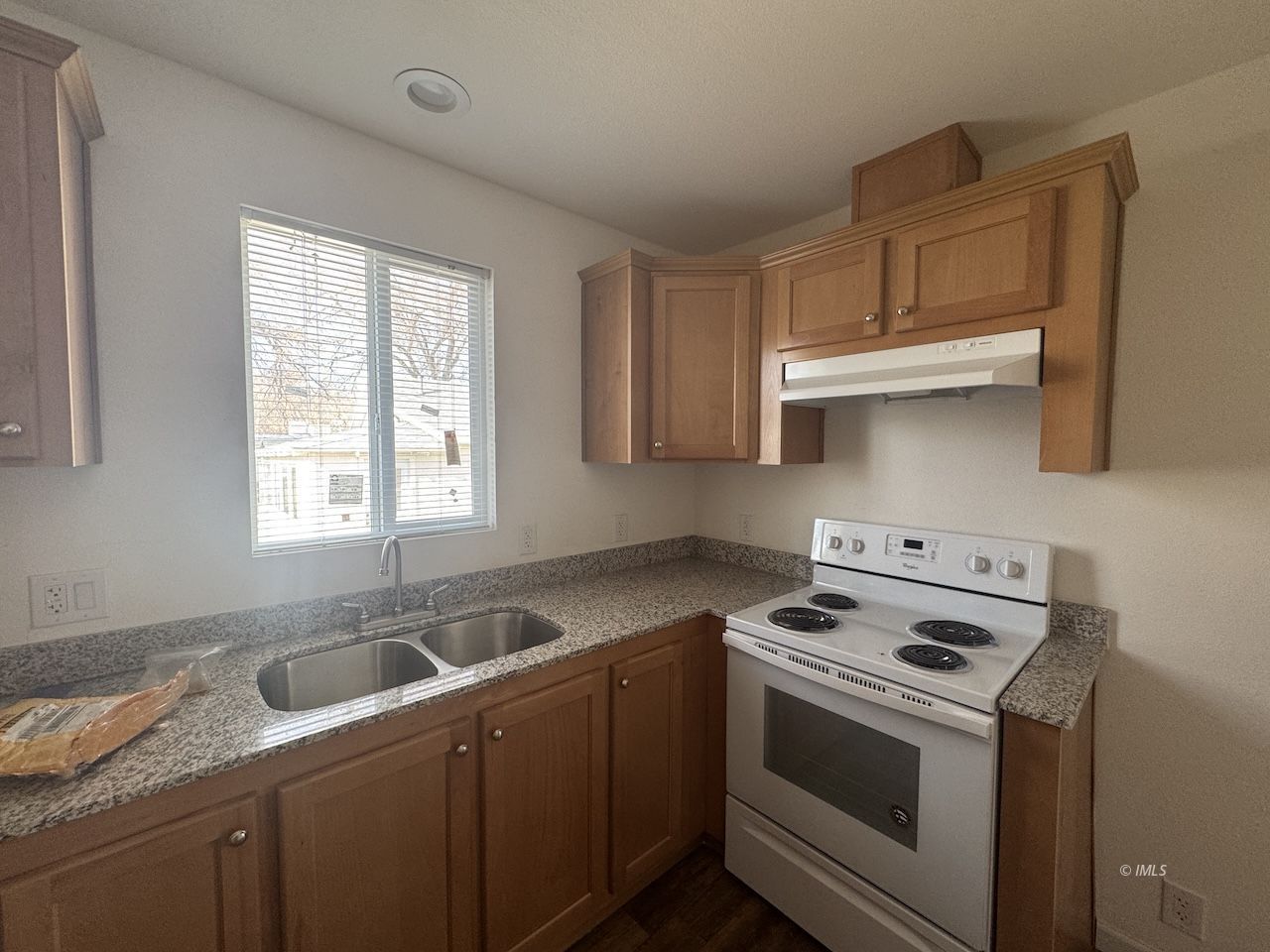 427 North Jackson Street Independence, CA 93526 - Photo 11 of 21 a kitchen with cabinets appliances a sink and a window
