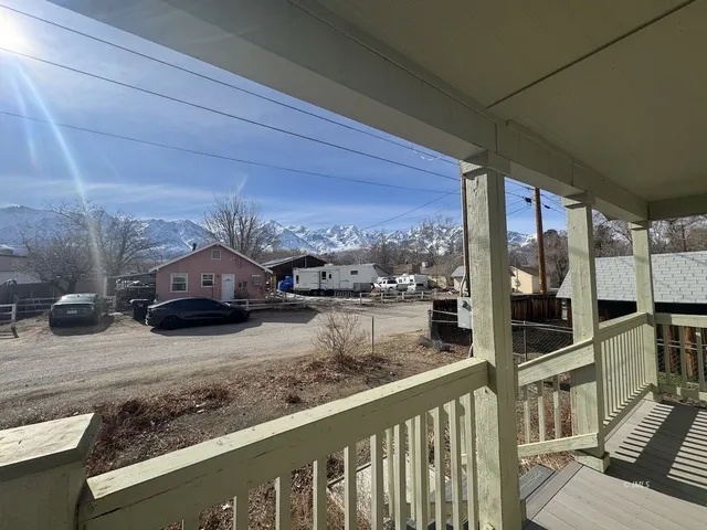 a view of a car parked on the side of a street