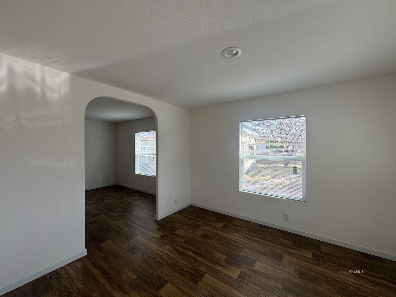 427 North Jackson Street Independence, CA 93526 - Photo 6 of 21 a view of an empty room with wooden floor and a window