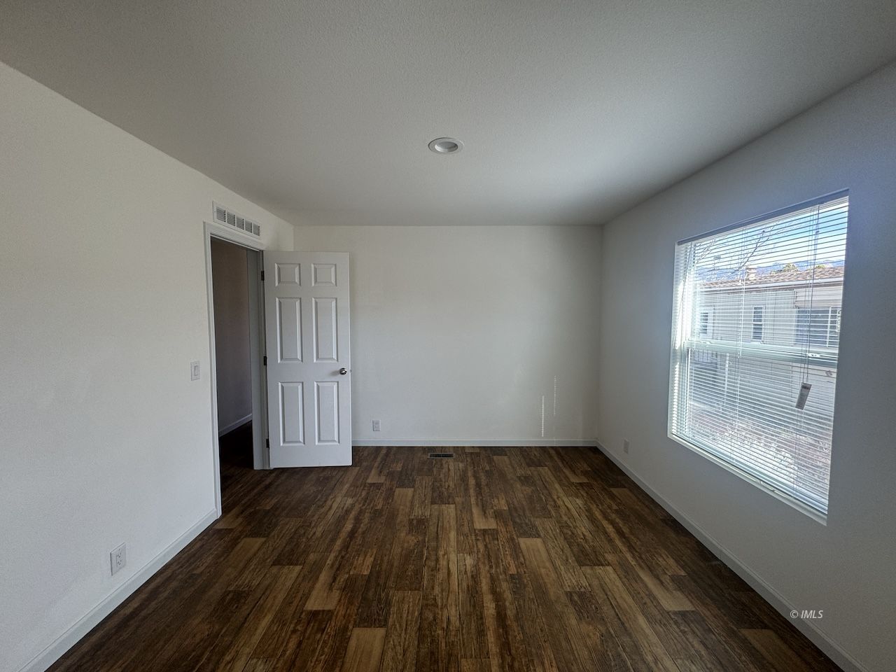 427 North Jackson Street Independence, CA 93526 - Photo 8 of 21 a view of empty room with wooden floor and fan