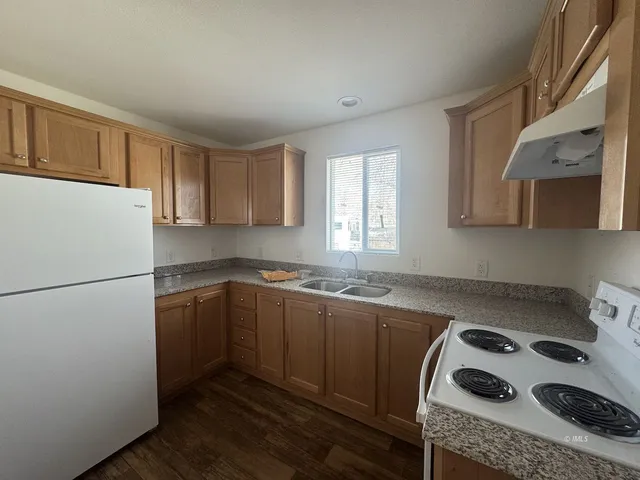 a kitchen with a sink a stove and cabinets