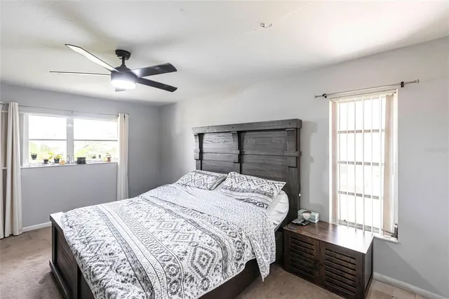 a bedroom with a large bed and a window