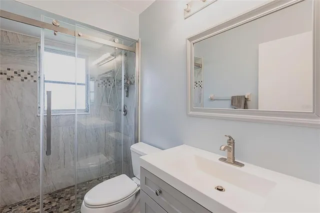 a bathroom with a sink toilet and shower