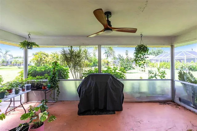 a black and white umbrella sitting in a room next to a yard