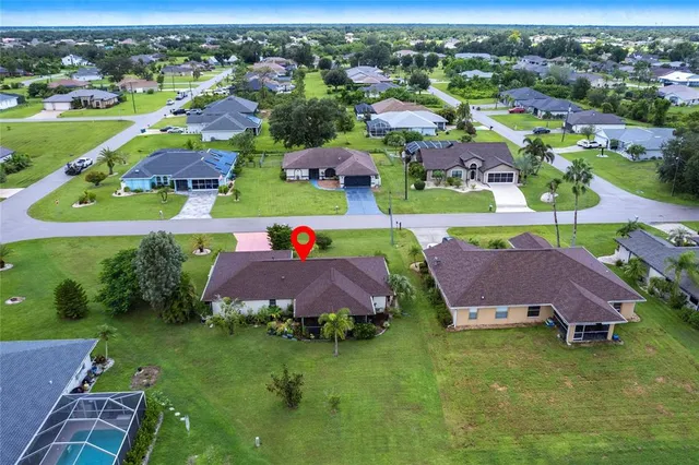 an aerial view of residential houses with outdoor space and street view