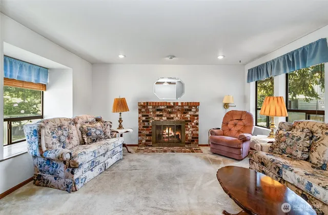 a living room with furniture gym equipment and a large window