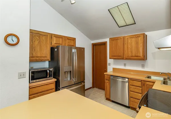 a kitchen that has a refrigerator and a stove