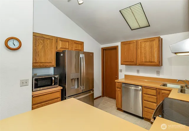 a kitchen that has a refrigerator and a stove