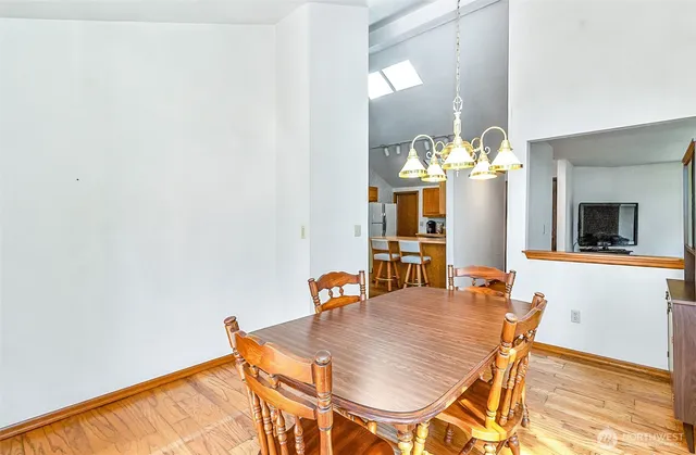 a dining room with furniture and wooden floor