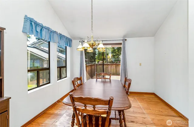 a dining room with furniture and window