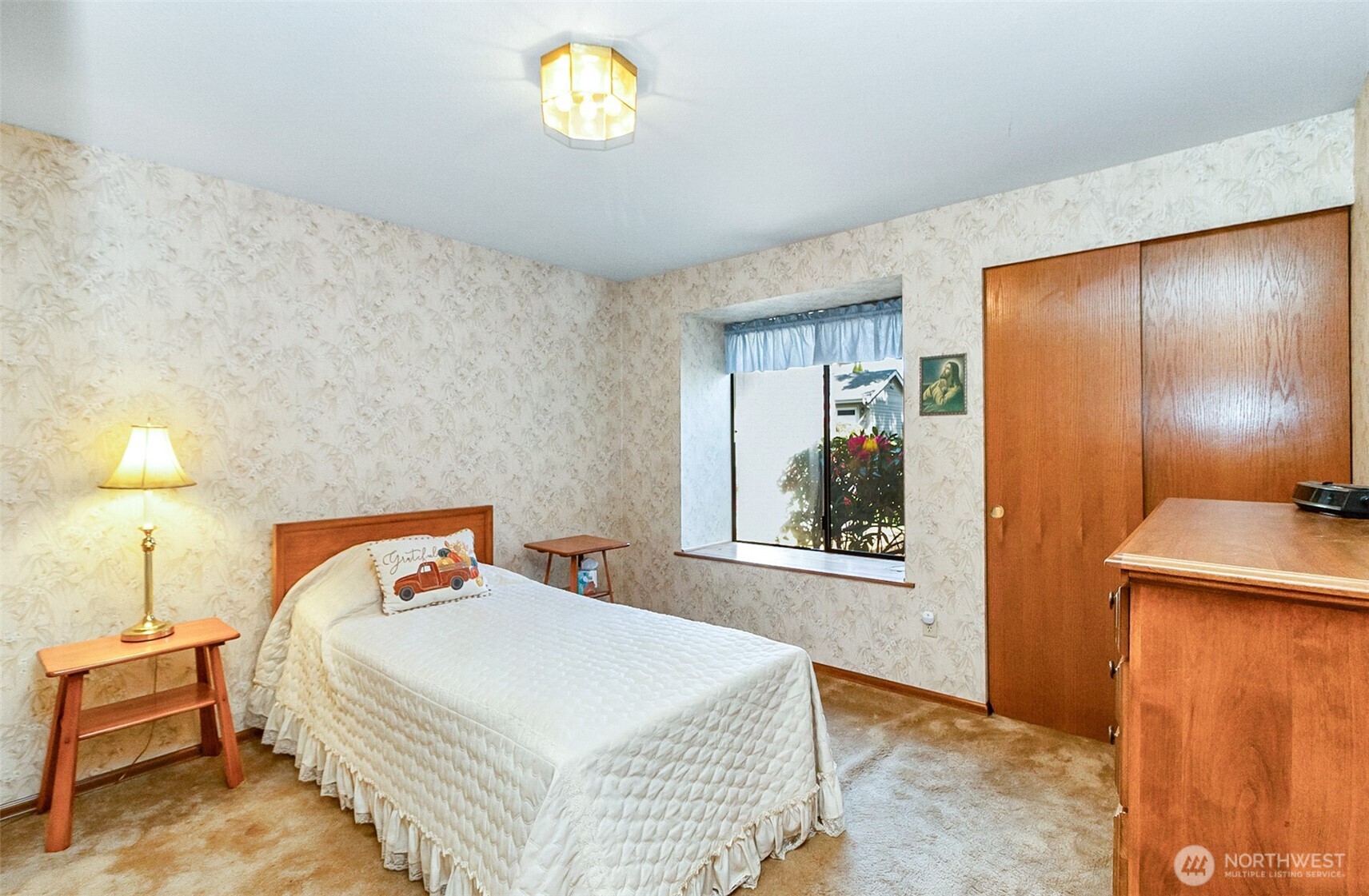 1324 Boise Street Fircrest, WA 98466 - Photo 27 of 39 a bedroom with a bed and a lamp on table