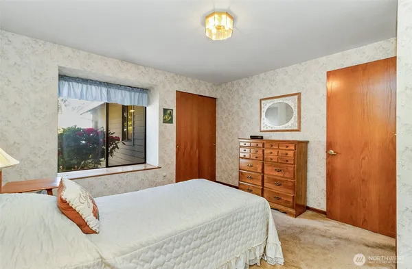 a bedroom with a bed and a dresser