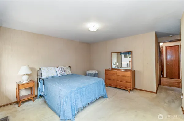 a bedroom with a bed and a dresser