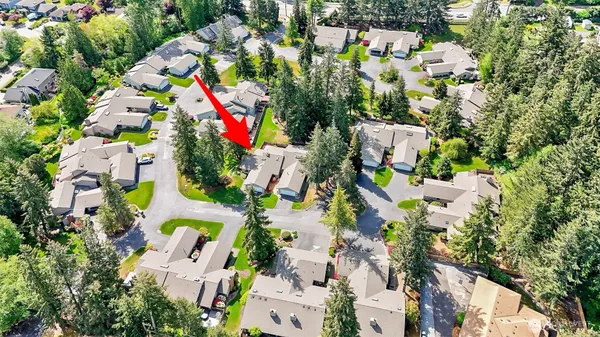 an aerial view of residential houses with outdoor space and street view