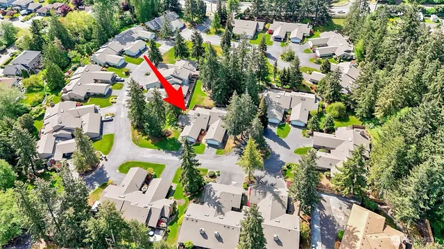 an aerial view of residential houses with outdoor space and street view