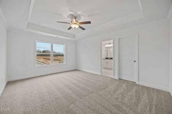a view of empty room with wooden floor and window
