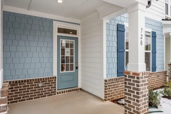 a kitchen with kitchen island granite countertop a sink and a refrigerator