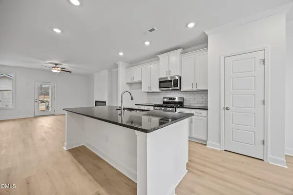 a view of a kitchen with a sink and cabinet