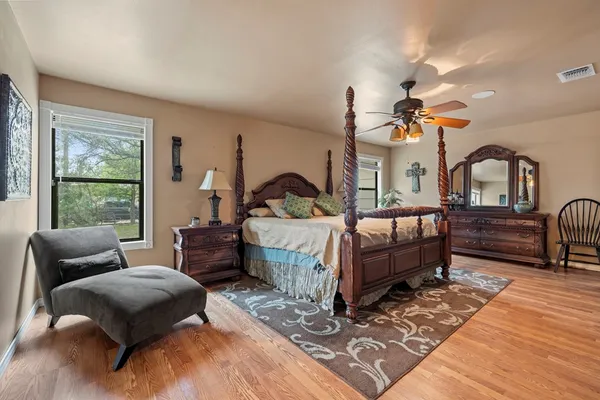 a bedroom with a bed and a chandelier