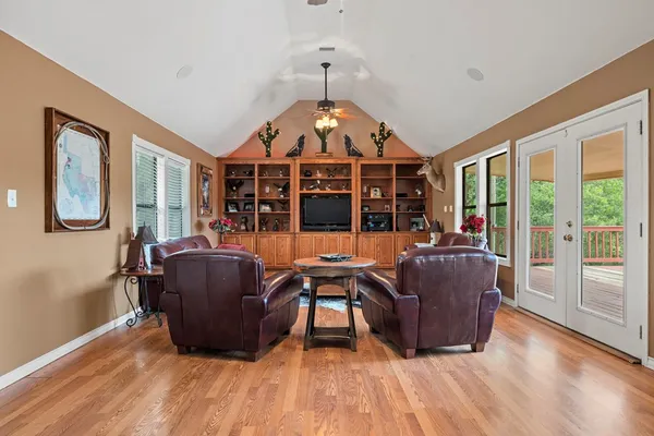 a living room with furniture and wooden floor
