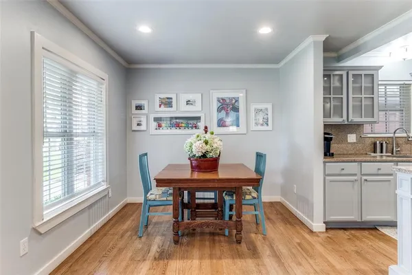 a living room with furniture and a dining table with kitchen view