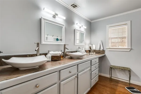 a bathroom with a double vanity sink and a mirror