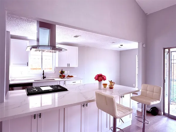 a kitchen with a sink cabinets and a window