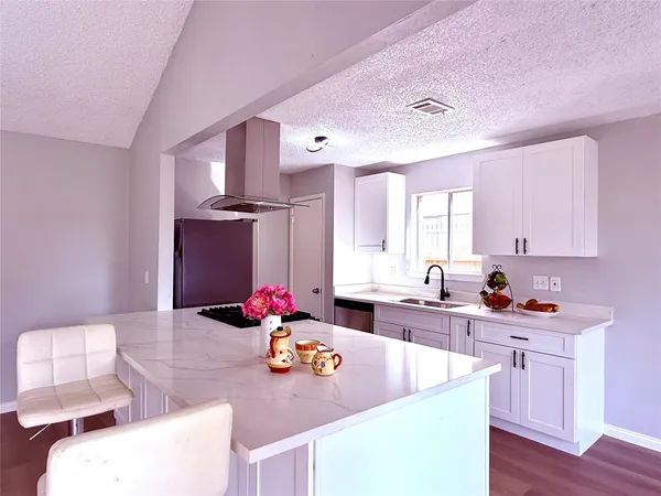 a kitchen with a sink stove and cabinets