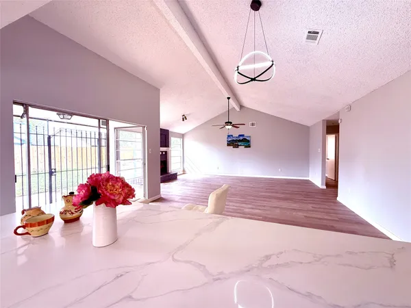 a hallway with a chandelier and couch