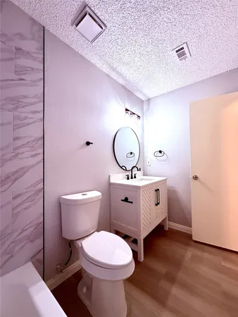 a room with a toilet and a mirror