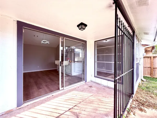 a view of backyard with wooden fence
