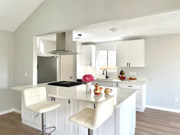 a kitchen with a sink cabinets and window