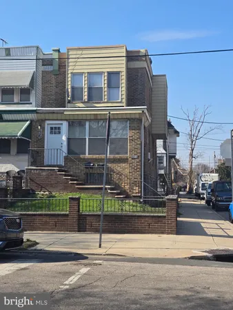 a view of a brick building next to a road