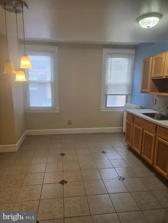 a kitchen with a sink a stove and window