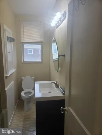 a bathroom with a sink a toilet and mirror